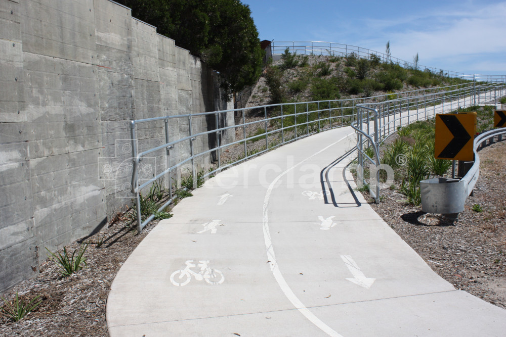 Tube clamp handrails protecting both sides of bike path entrance ramp